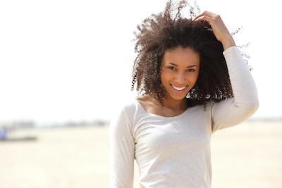 Woman smiling on the beach | Springfield Dentist