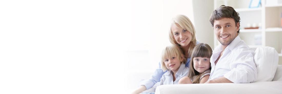 Family of four smiling at dentist office in Springfield MO