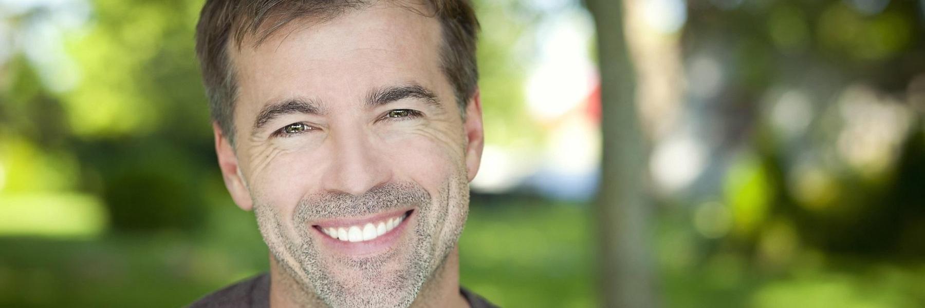 man smiling outdoors | Springfield MO Dentist