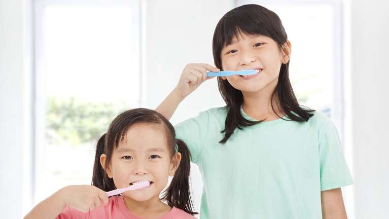Two children brushing their teeth | children's dentistry